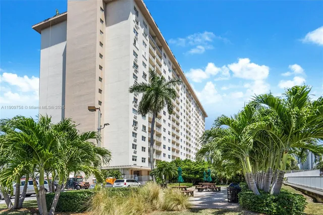 a view of a tall building with a tree in front