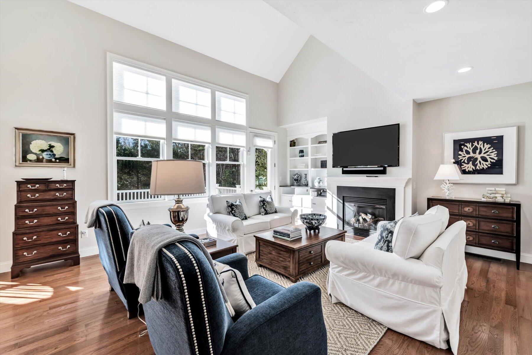 66 Eagle Drive Mashpee, MA 02649 - Photo 12 of 36 a living room with furniture a fireplace and a flat screen tv