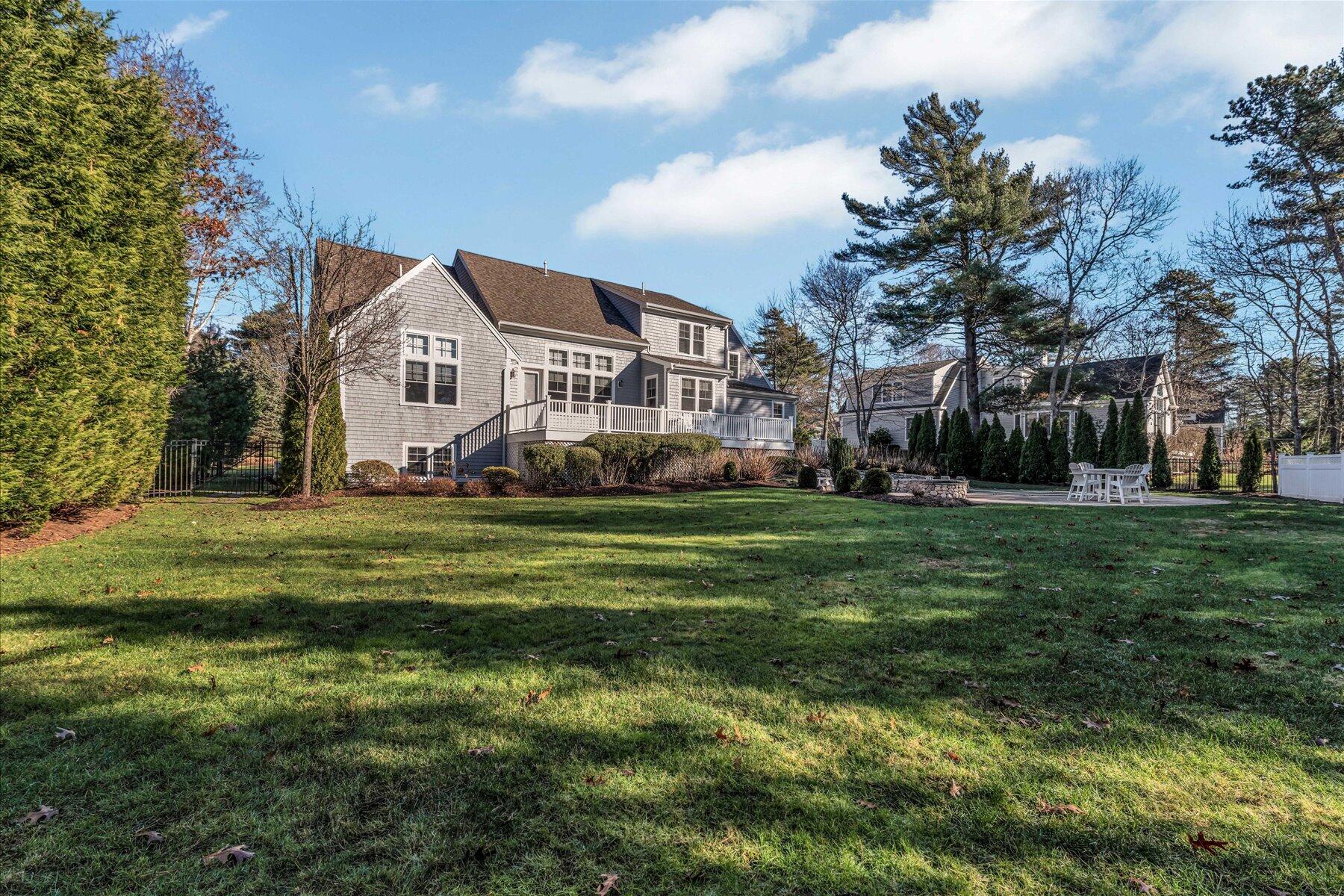 66 Eagle Drive Mashpee, MA 02649 - Photo 32 of 36 a front view of a house with a yard table and chairs