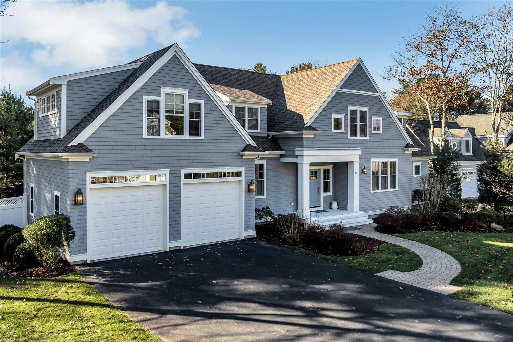 66 Eagle Drive Mashpee, MA 02649 - Photo 4 of 36 a front view of a house with a yard and garage