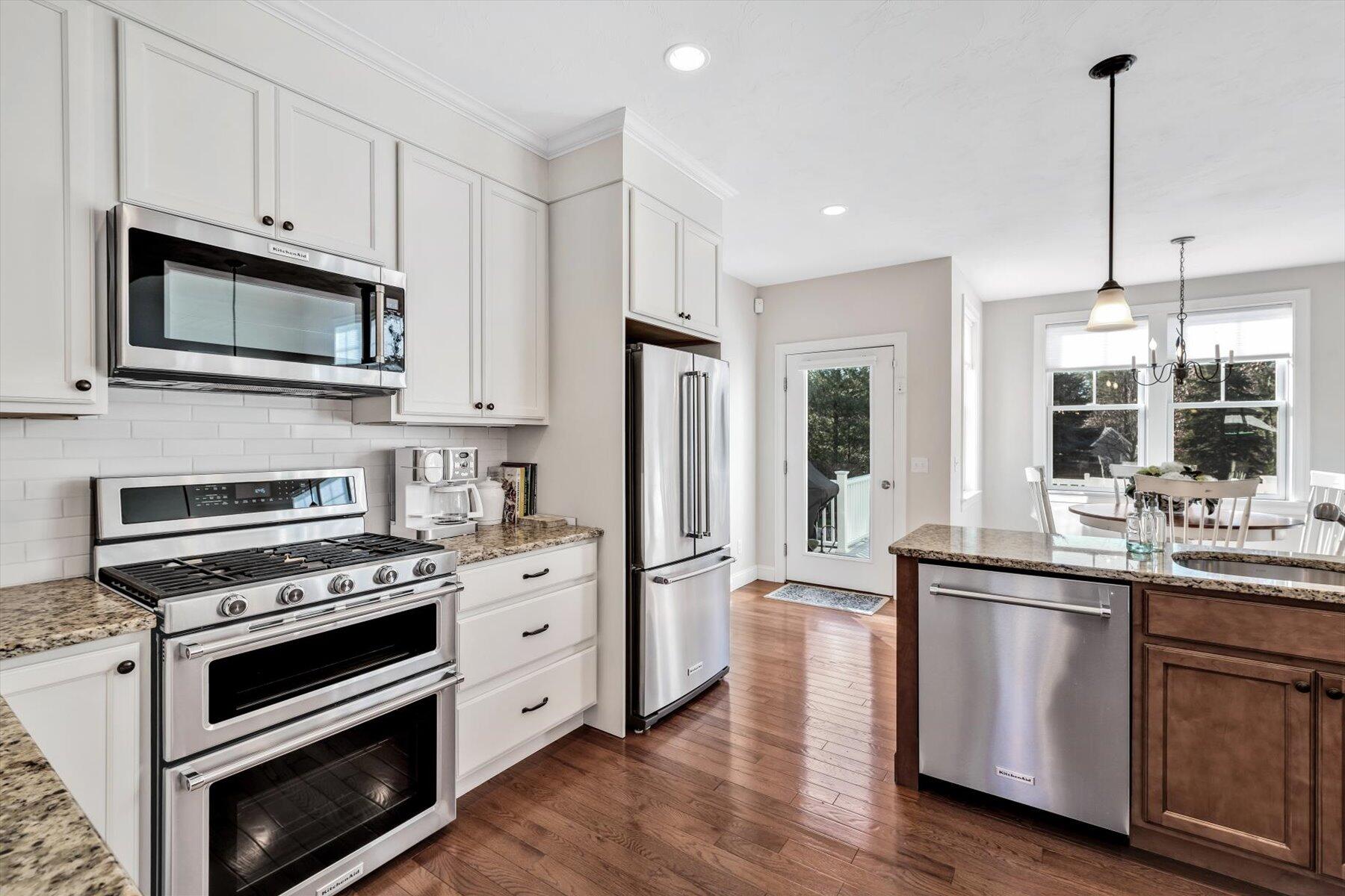 66 Eagle Drive Mashpee, MA 02649 - Photo 8 of 36 a kitchen with stainless steel appliances a stove microwave and refrigerator