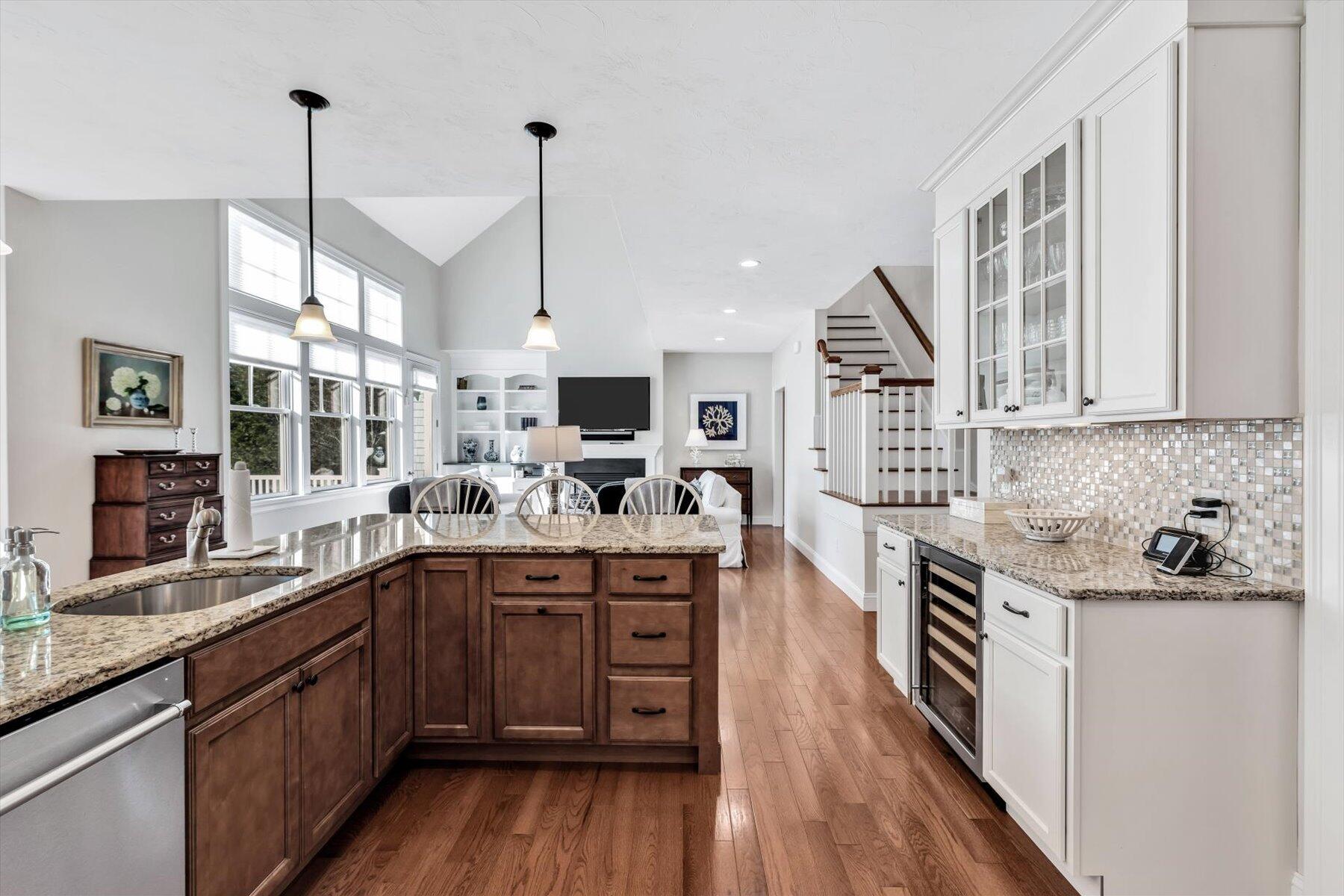 66 Eagle Drive Mashpee, MA 02649 - Photo 9 of 36 a kitchen with stainless steel appliances granite countertop a sink stove and wooden floor
