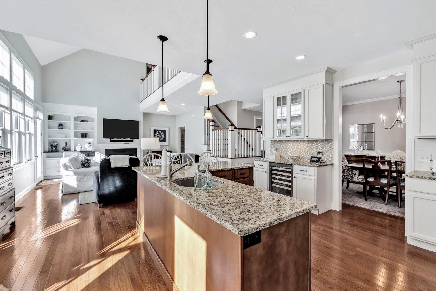 66 Eagle Drive Mashpee, MA 02649 - Photo 10 of 36 a kitchen with stainless steel appliances granite countertop a stove oven and a view of living room with a flat screen tv