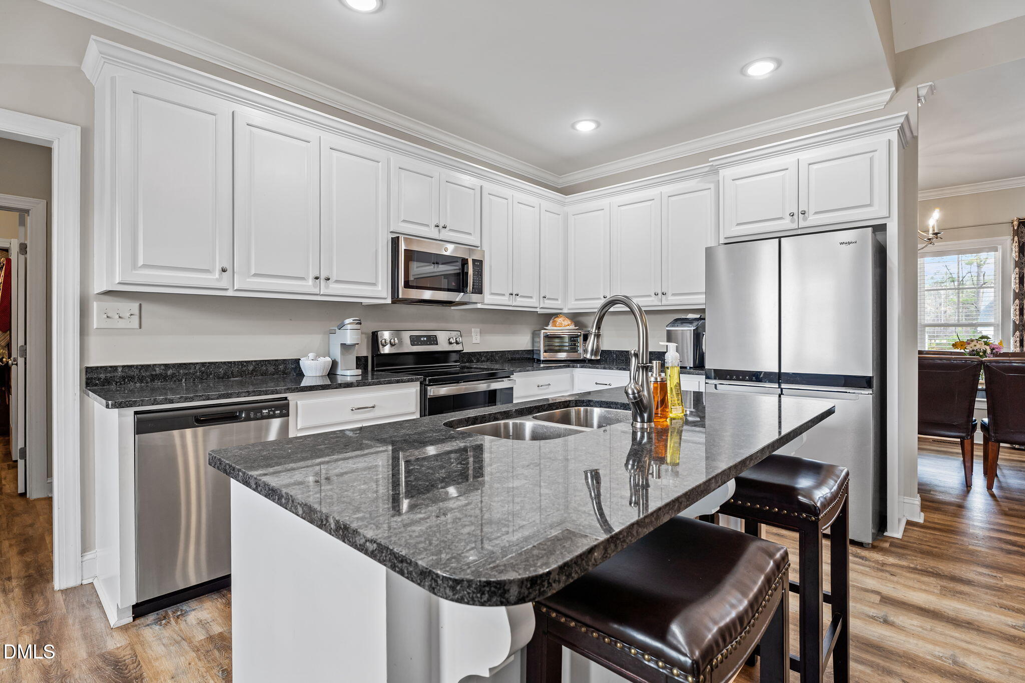 8772 Surrey Top Road Bailey, NC 27807 - Photo 12 of 42 a kitchen with kitchen island granite countertop stainless steel appliances and wooden cabinets