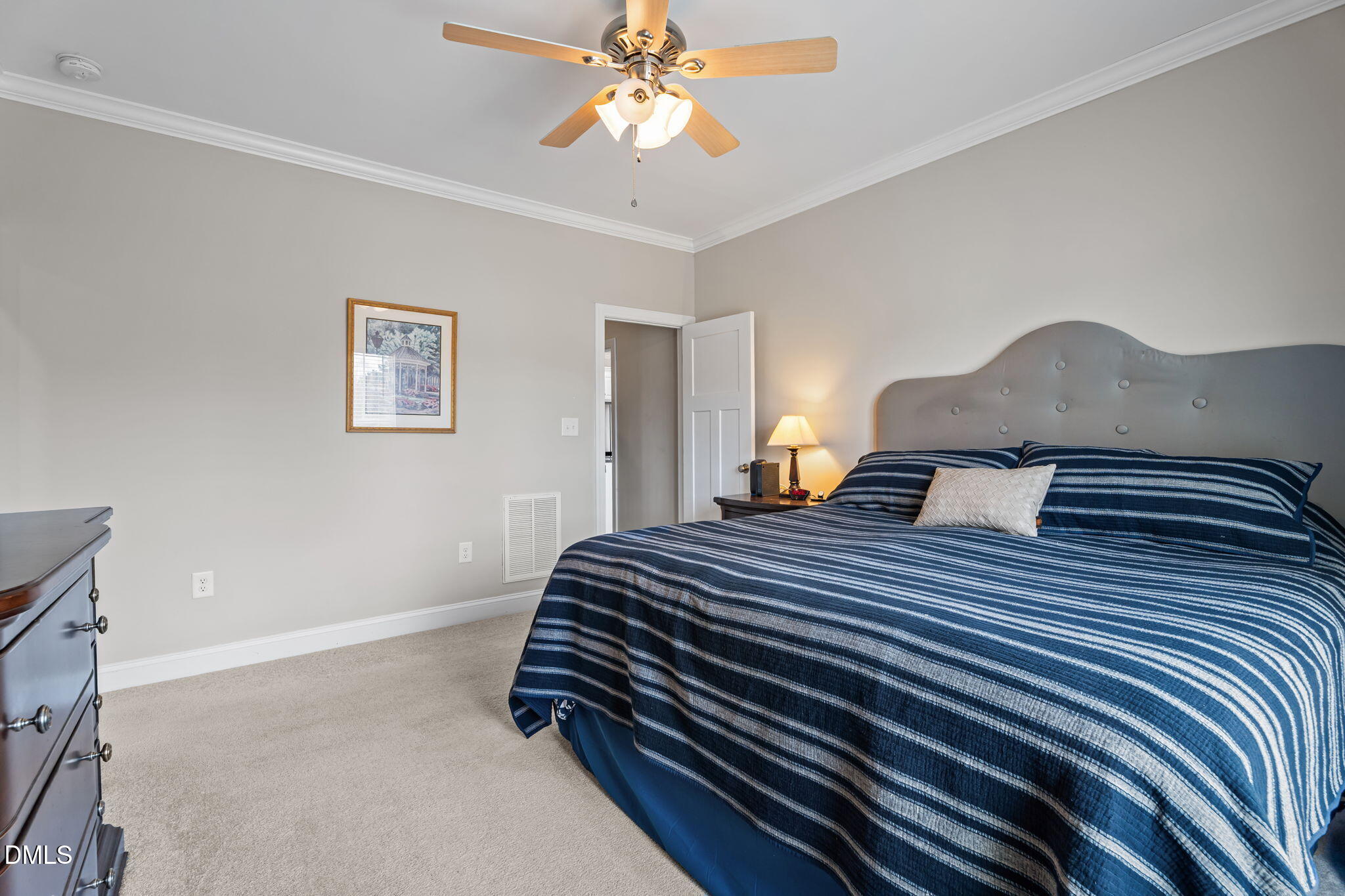 8772 Surrey Top Road Bailey, NC 27807 - Photo 18 of 42 a bedroom with a bed and a chandelier