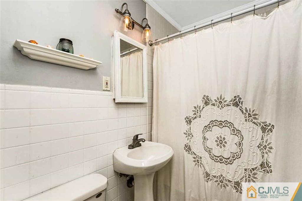 310 Howard Avenue Middlesex, NJ 08846 - Photo 13 of 25 a bathroom with a sink and a mirror