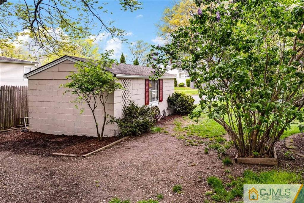 310 Howard Avenue Middlesex, NJ 08846 - Photo 20 of 25 a view of a house with a tree and a yard