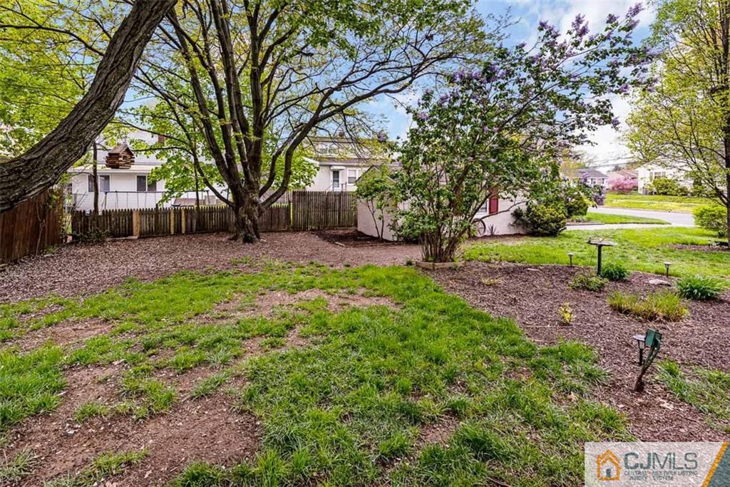 310 Howard Avenue Middlesex, NJ 08846 - Photo 24 of 25 a view of a backyard with large trees and plants