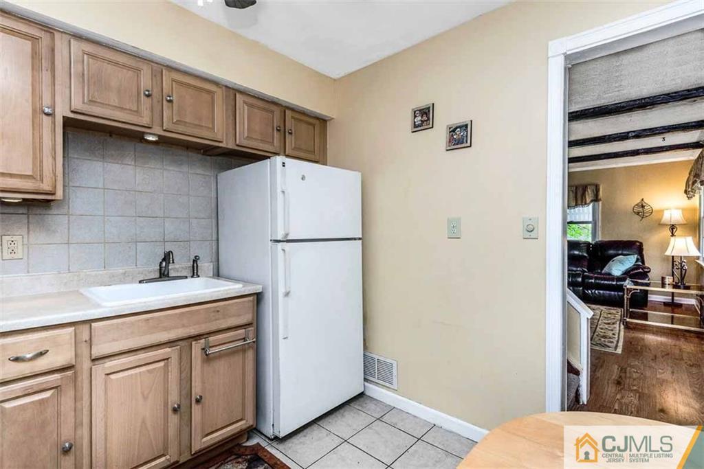 310 Howard Avenue Middlesex, NJ 08846 - Photo 6 of 25 a kitchen with a sink a refrigerator and cabinets