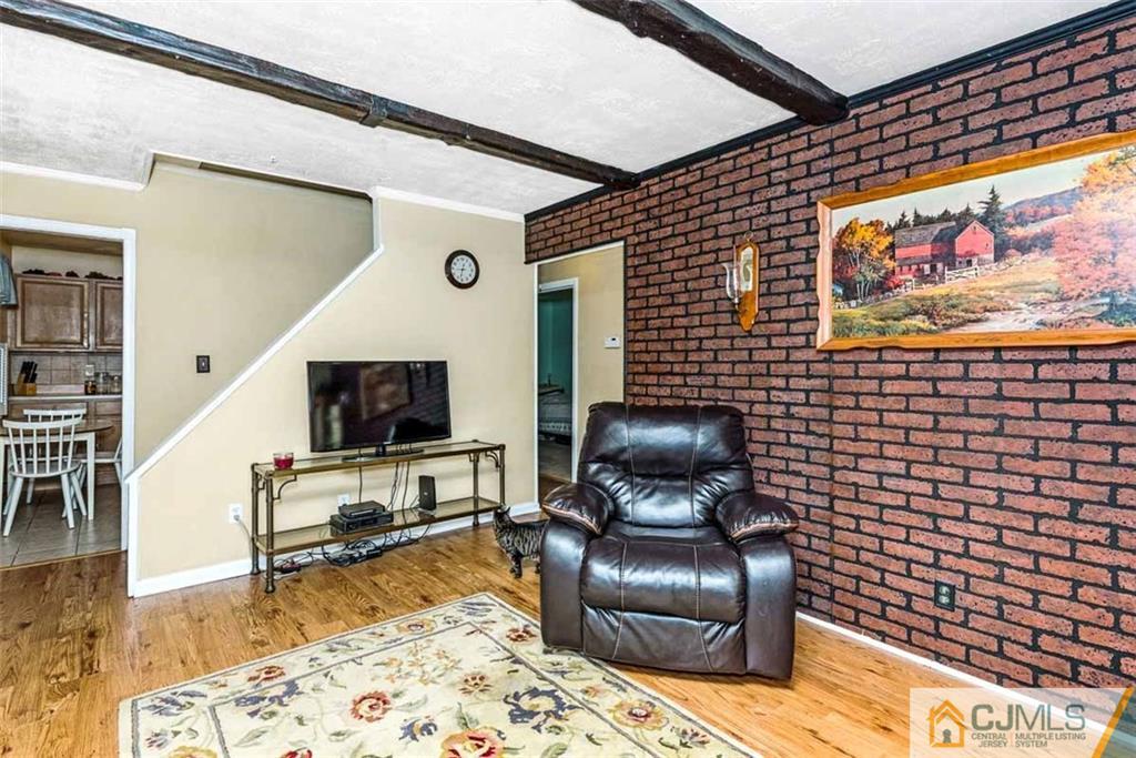 310 Howard Avenue Middlesex, NJ 08846 - Photo 8 of 25 a living room with couch chair and a flat screen tv