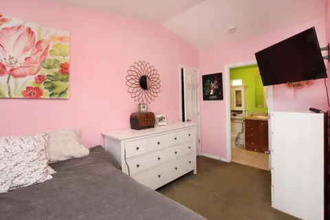 a bedroom with a bed and flat screen tv