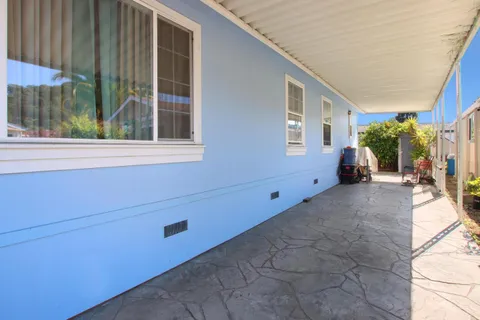 a view of a house with backyard and porch