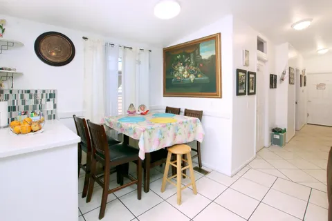 a dining room with furniture and chandelier