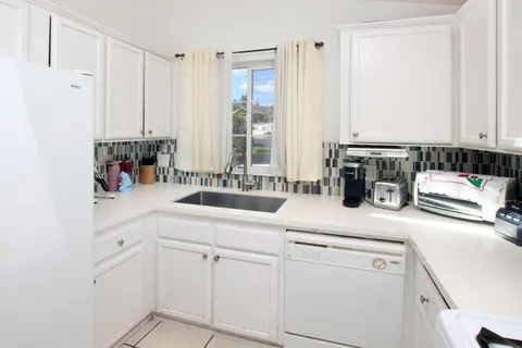 a utility room with sink dryer and washer