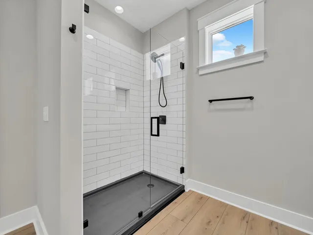 a bedroom with a large bed and a potted plant