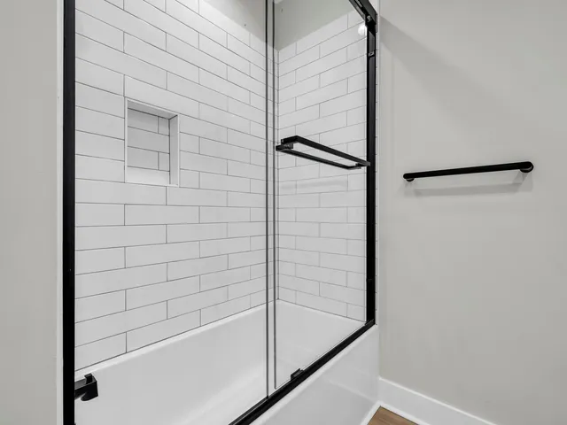 a bathroom with a granite countertop toilet sink and mirror