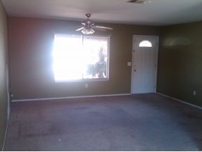 2140 Northeast Clover Palm Bay, FL 32905 - Photo 4 of 8 an empty room that has a window and chandelier fan