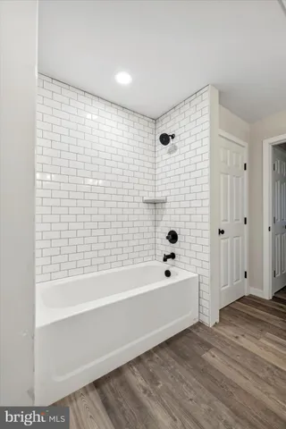 a bathroom with a bathtub and shower