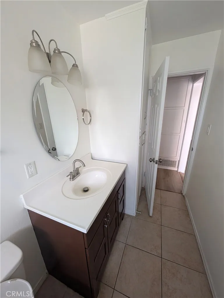 8641 Garfield Street, Unit 1 Riverside, CA 92504 - Photo 12 of 19 a bathroom with a sink and mirror