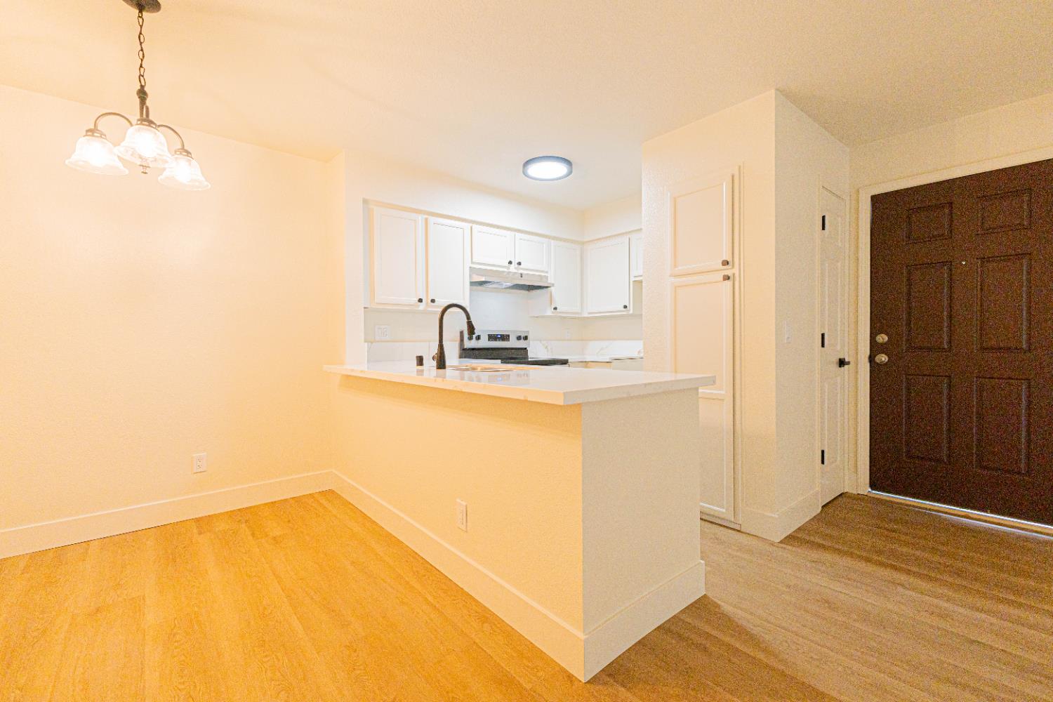 2909 Huntington Boulevard, Unit 107 Fresno, CA 93721 - Photo 4 of 9 a kitchen with a sink cabinets and wooden floor