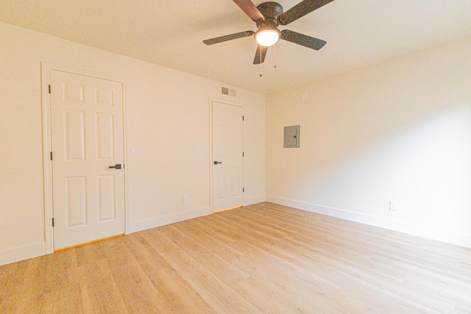 2909 Huntington Boulevard, Unit 107 Fresno, CA 93721 - Photo 6 of 9 an empty room with a ceiling fan and a window