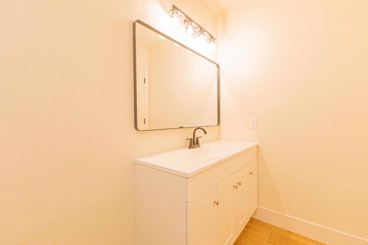 2909 Huntington Boulevard, Unit 107 Fresno, CA 93721 - Photo 8 of 9 a bathroom with a sink and a mirror