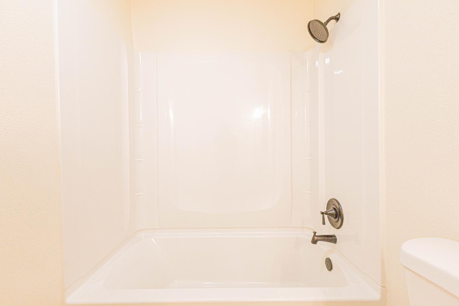 2909 Huntington Boulevard, Unit 107 Fresno, CA 93721 - Photo 9 of 9 a bathroom with a bathtub