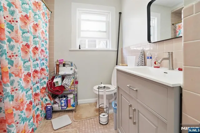 a bathroom with a sink toilet and window