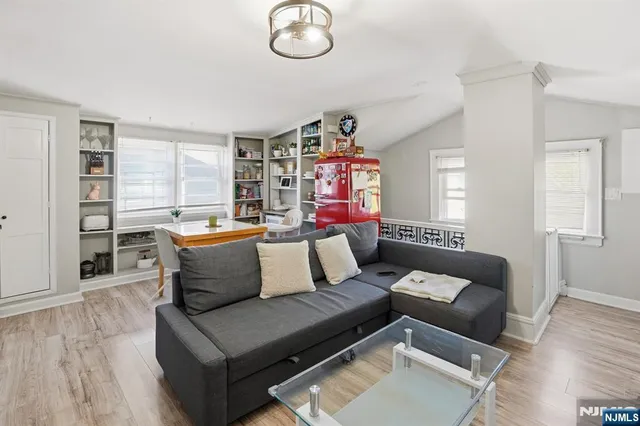 a living room with furniture kitchen and a window