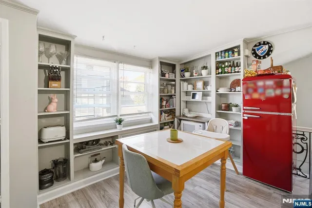 a room with a table chair and a window