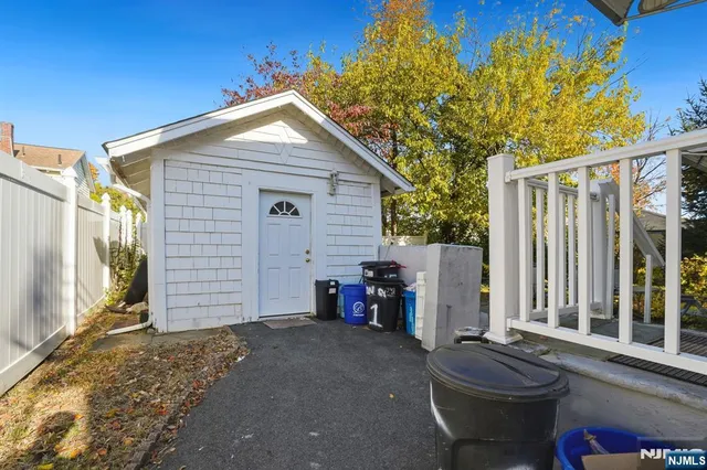 a patio with table and chairs and potted plants