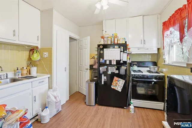 a kitchen with stainless steel appliances a stove a sink and a refrigerator