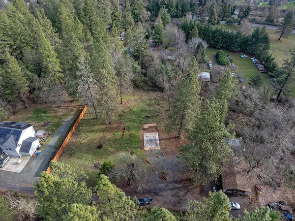 an aerial view of a house with a yard