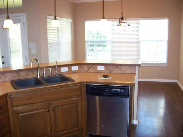 a kitchen with a sink and wooden cabinets