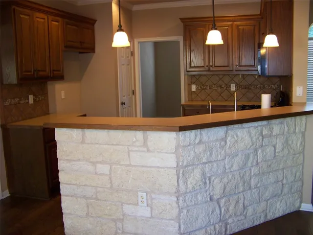 a view of a kitchen with a sink and a fireplace