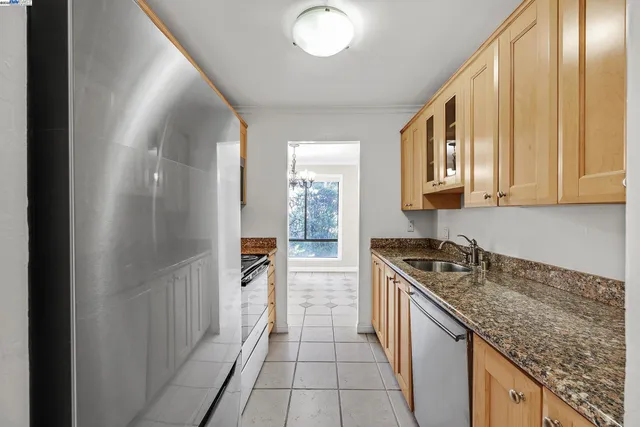 a kitchen with stainless steel appliances granite countertop a sink stove and cabinets