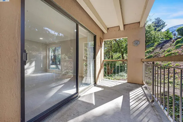 a front view of a multi story residential apartment building with yard and parking space