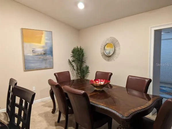 a view of a dining room with furniture and a potted plant