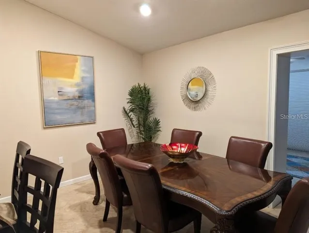a view of a dining room with furniture and a potted plant