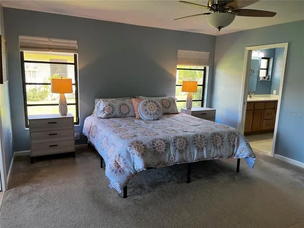 a bedroom with a bed dresser and a window