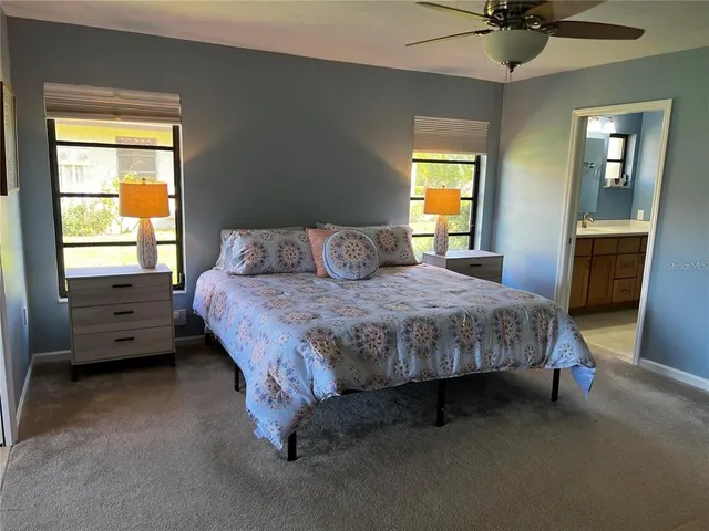 a bedroom with a bed dresser and a window