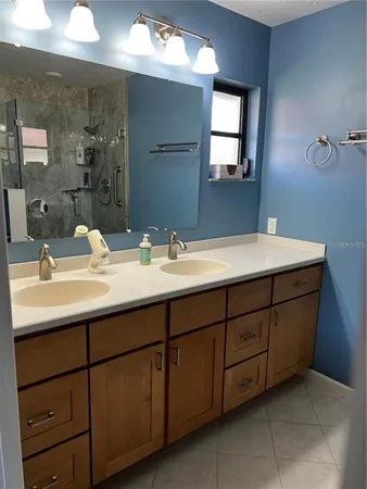 a bathroom with a double vanity sink and mirror
