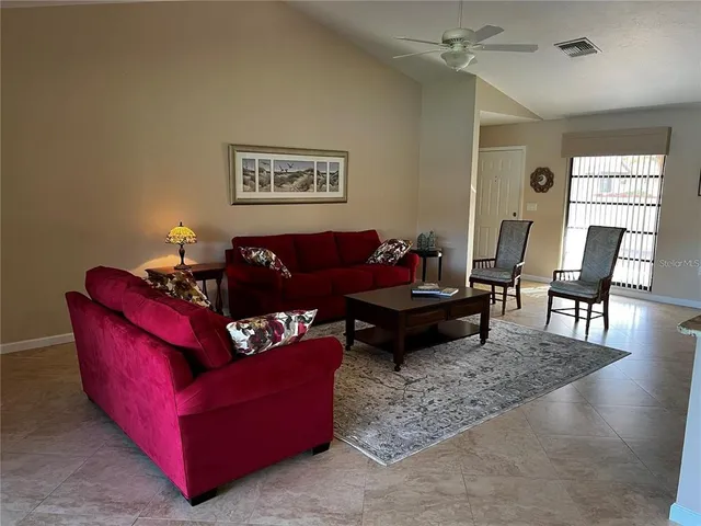 a living room with furniture rug and window