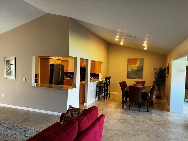 a living room with furniture a dining table and chairs