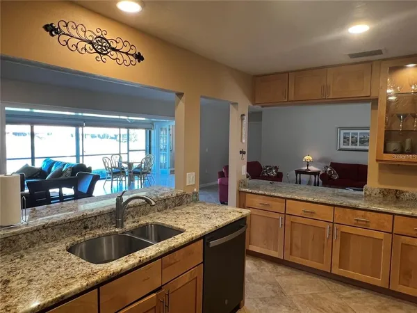 a kitchen with granite countertop a sink and a counter top space