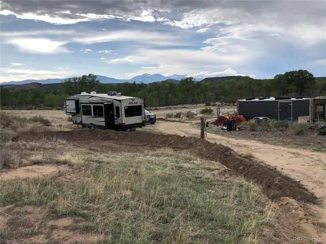 a view of a house with truck parked on the road
