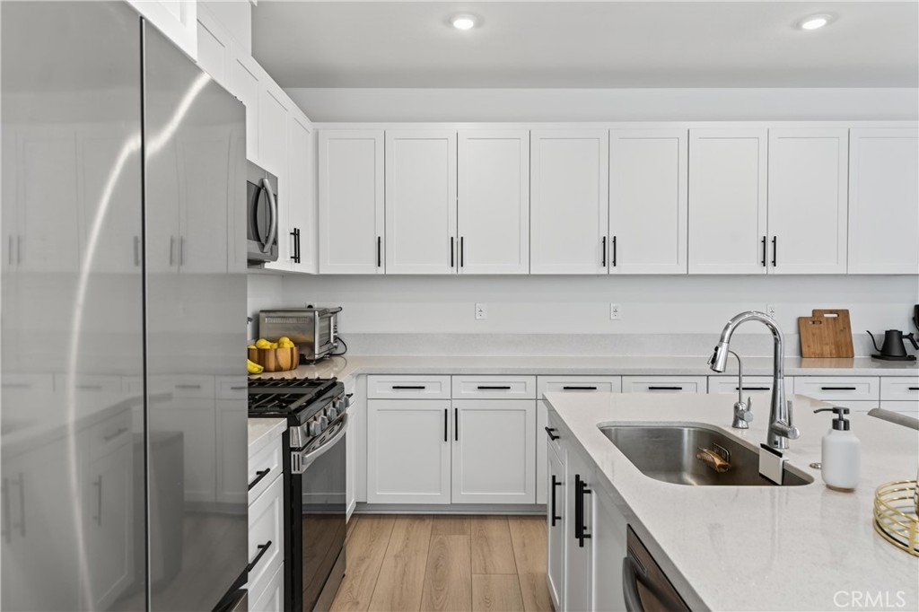 1572 Lima Way, Unit 6 Placentia, CA 92870 - Photo 16 of 36 a kitchen with a sink cabinets and appliances