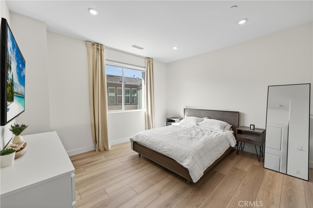 1572 Lima Way, Unit 6 Placentia, CA 92870 - Photo 23 of 36 a bedroom with a bed and a flat screen tv