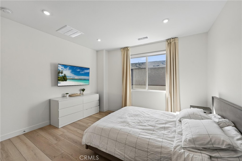 1572 Lima Way, Unit 6 Placentia, CA 92870 - Photo 24 of 36 a bedroom with a bed and a flat screen tv