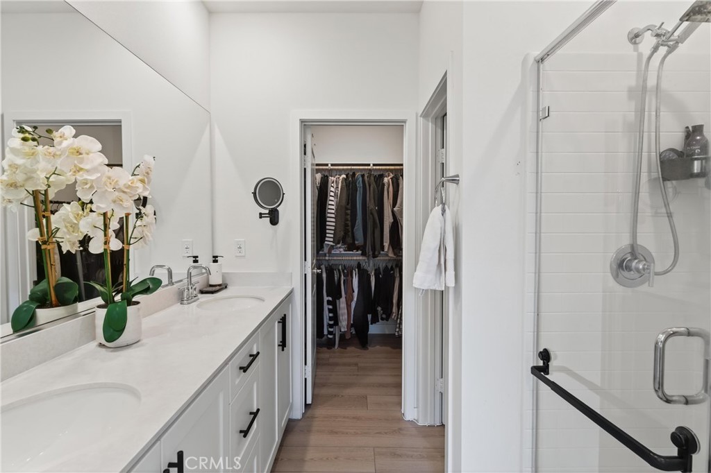 1572 Lima Way, Unit 6 Placentia, CA 92870 - Photo 27 of 36 a bathroom with a double vanity sink a mirror a vanity and shower